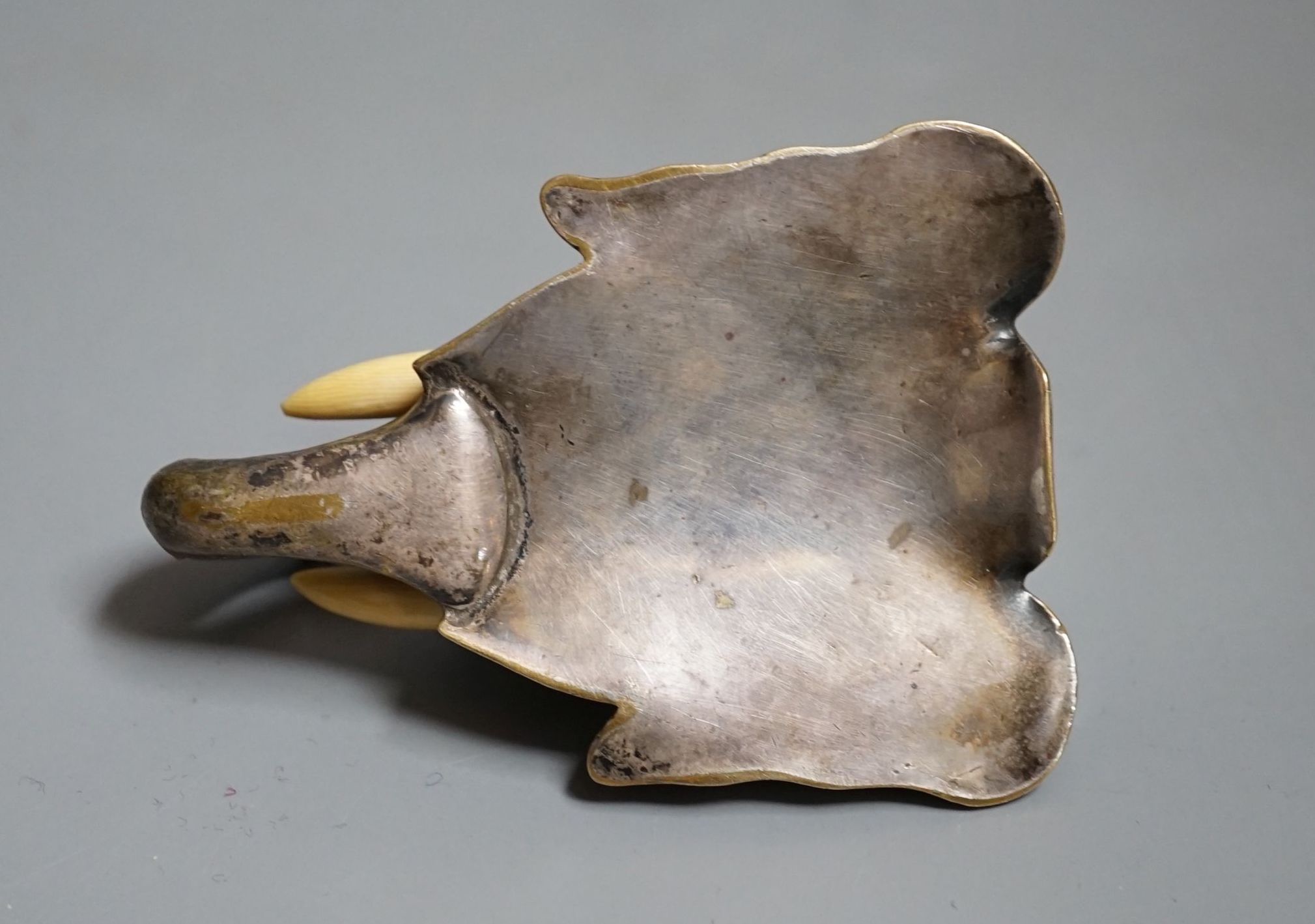 A bronze elephant head paperweight, early 20th century, with ivory inset tusks - 9cm high